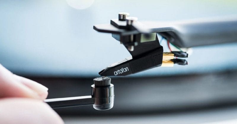 record player stylus being cleaned using a stylus brush